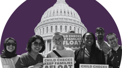 Smiling group of people holding signs advocating for cash tax credits in front of the US capitol building